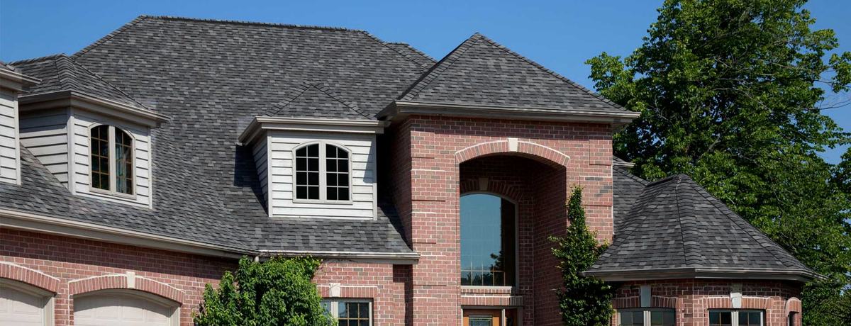 Brick two-story home showing the selected roof shingle color
